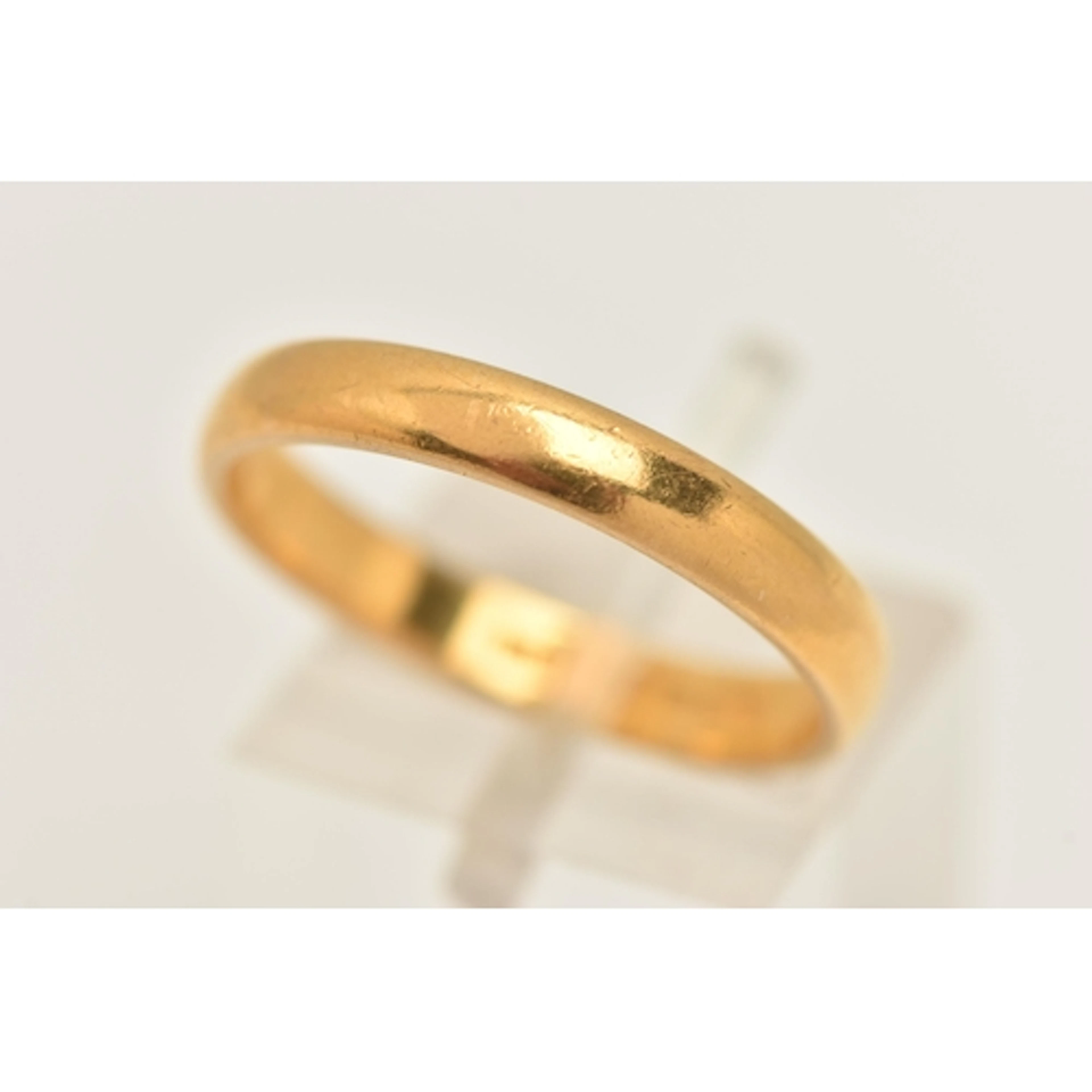 A 22CT GOLD BAND RING, a plain polished yellow gold band rin...