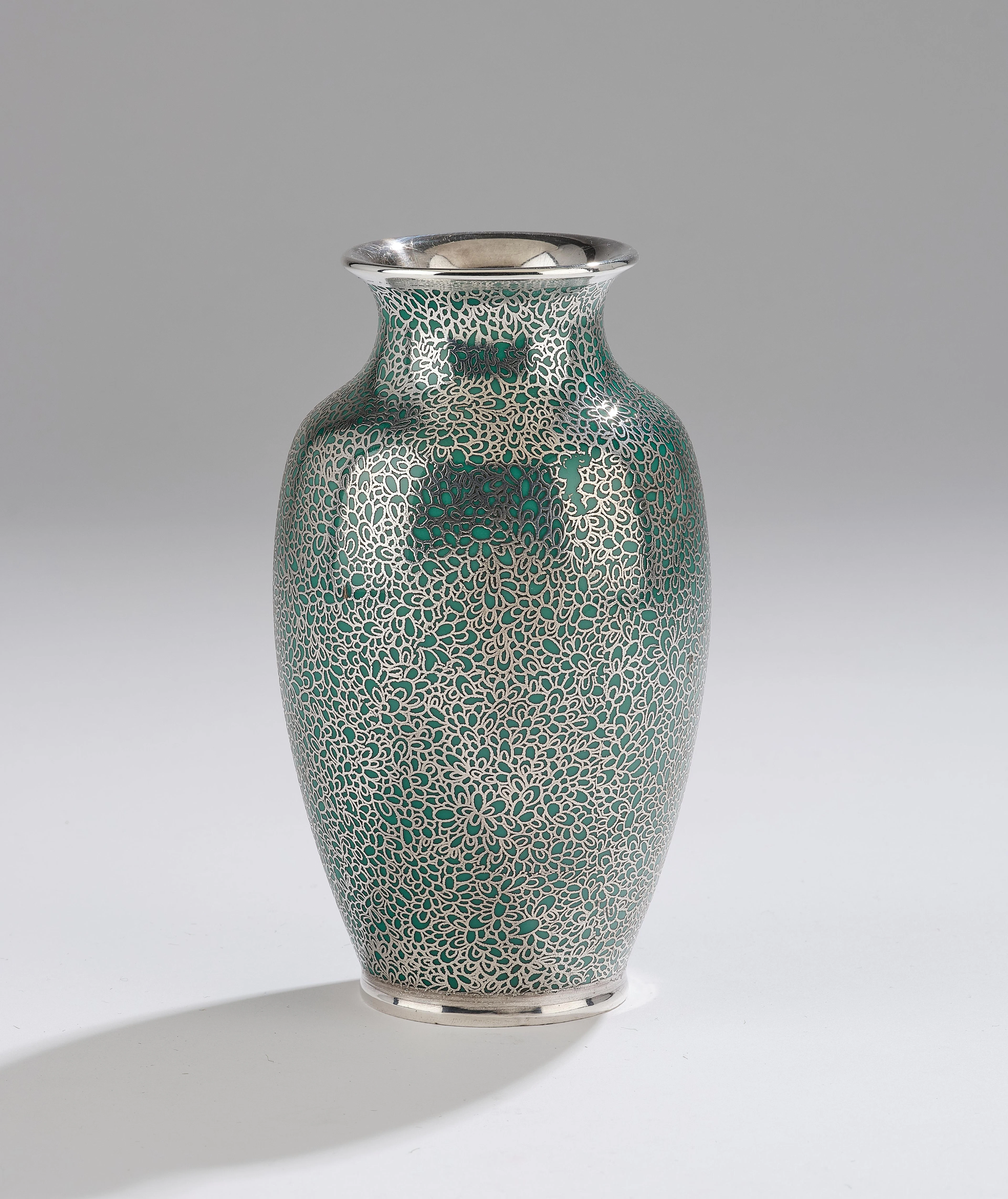 A vase with floral silver overlay