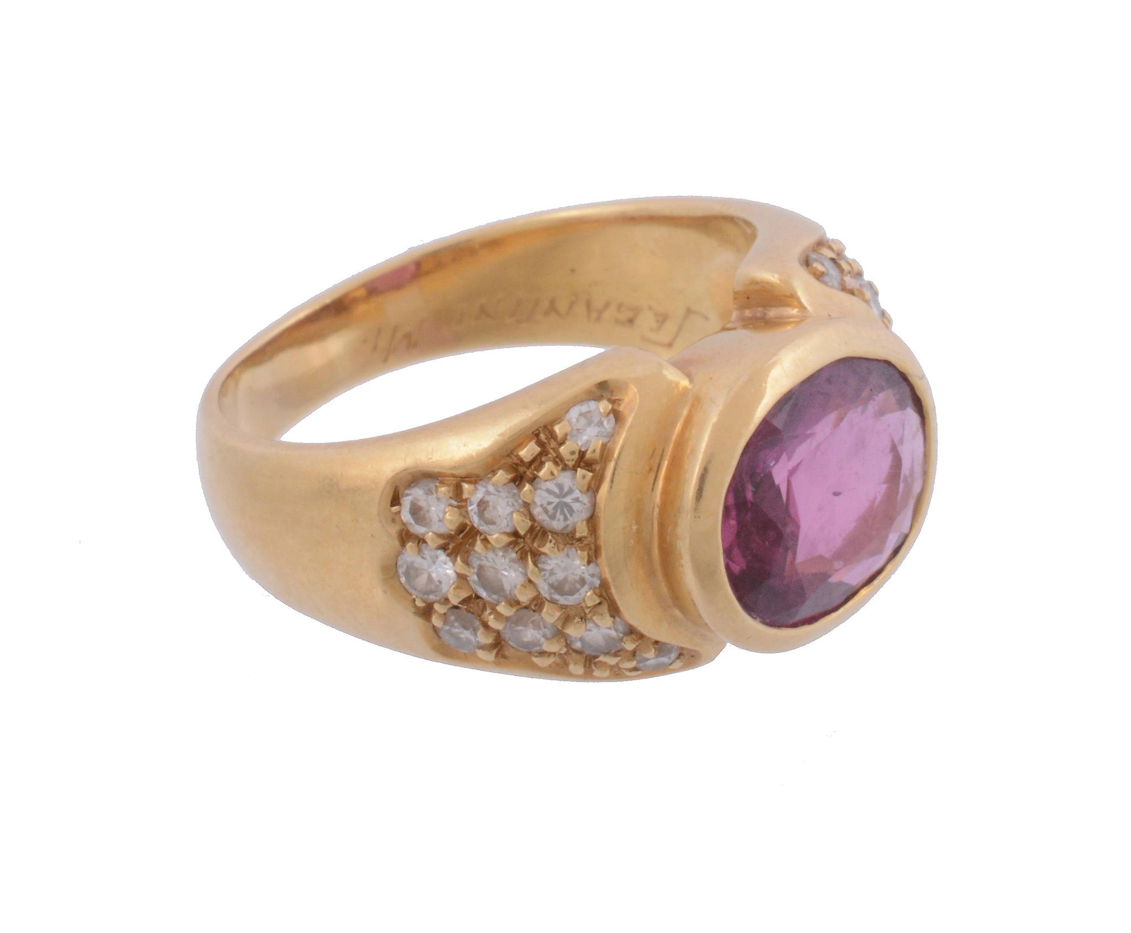 A ruby and diamond ring, the oval shaped ruby in a collet setting