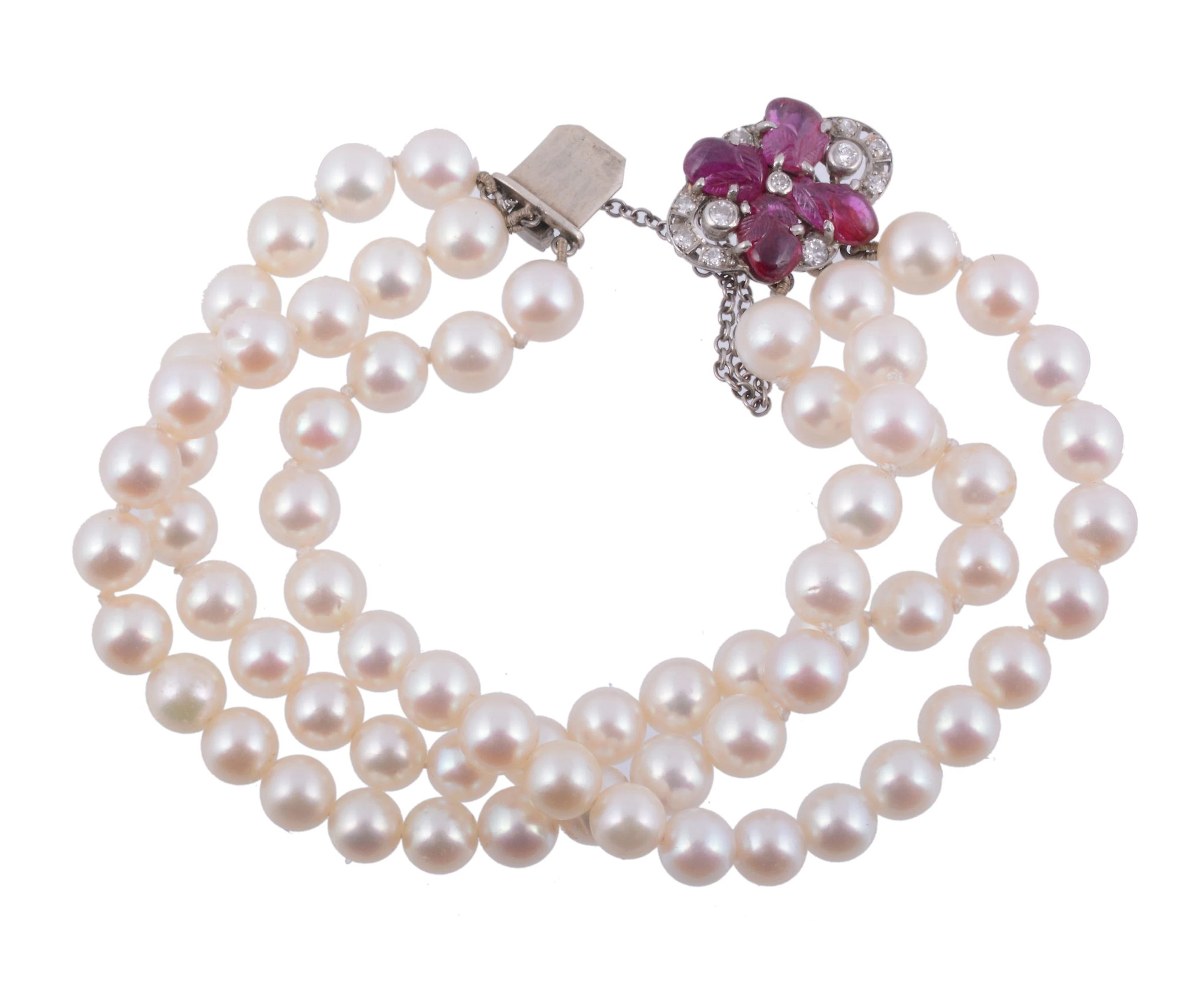 A cultured pearl bracelet with a diamond and ruby clasp