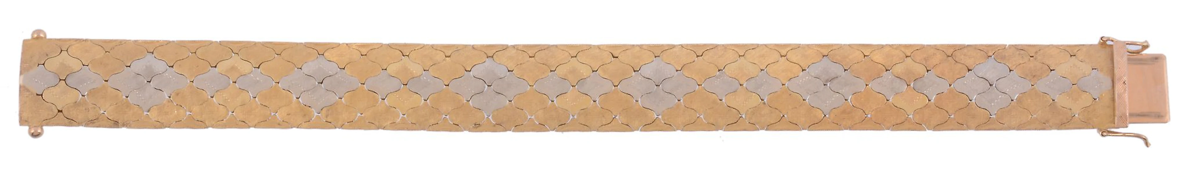 A two colour broad bracelet, circa 1970, with shaped textured panels