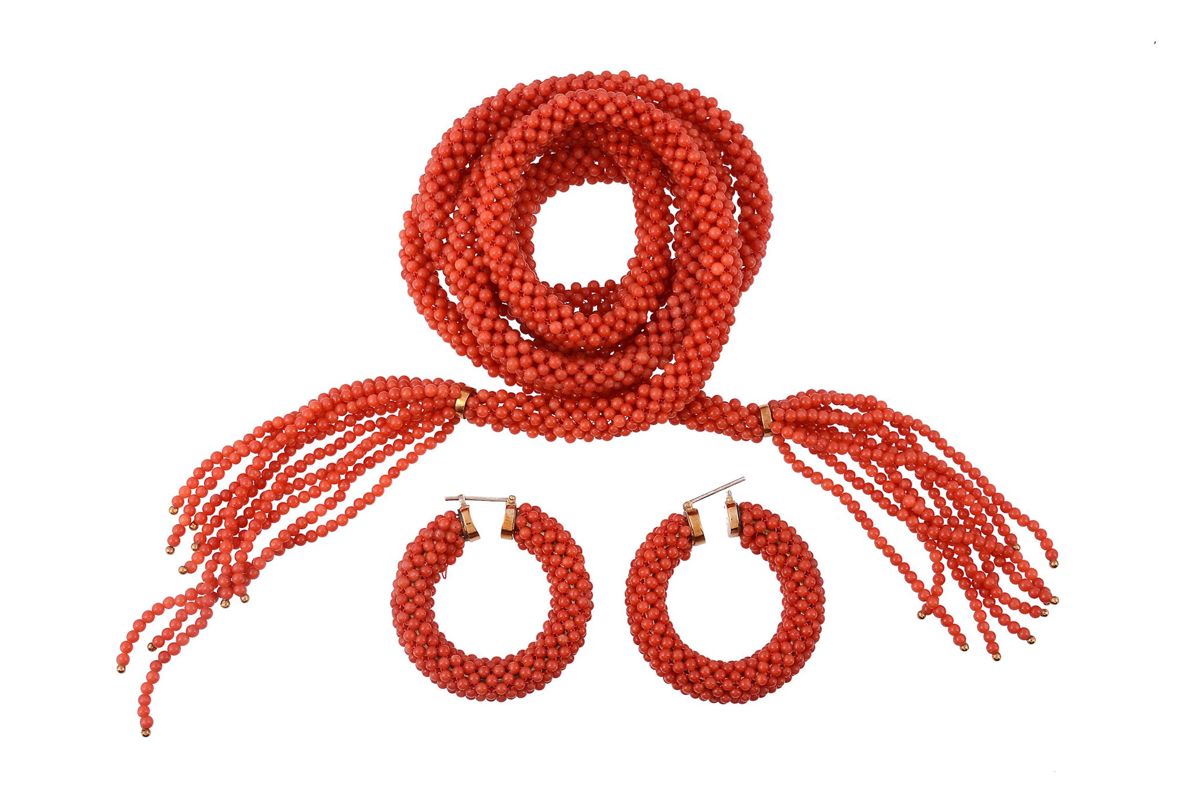 A coral sautoir, composed of polished coral beads, with fringed coral terminals