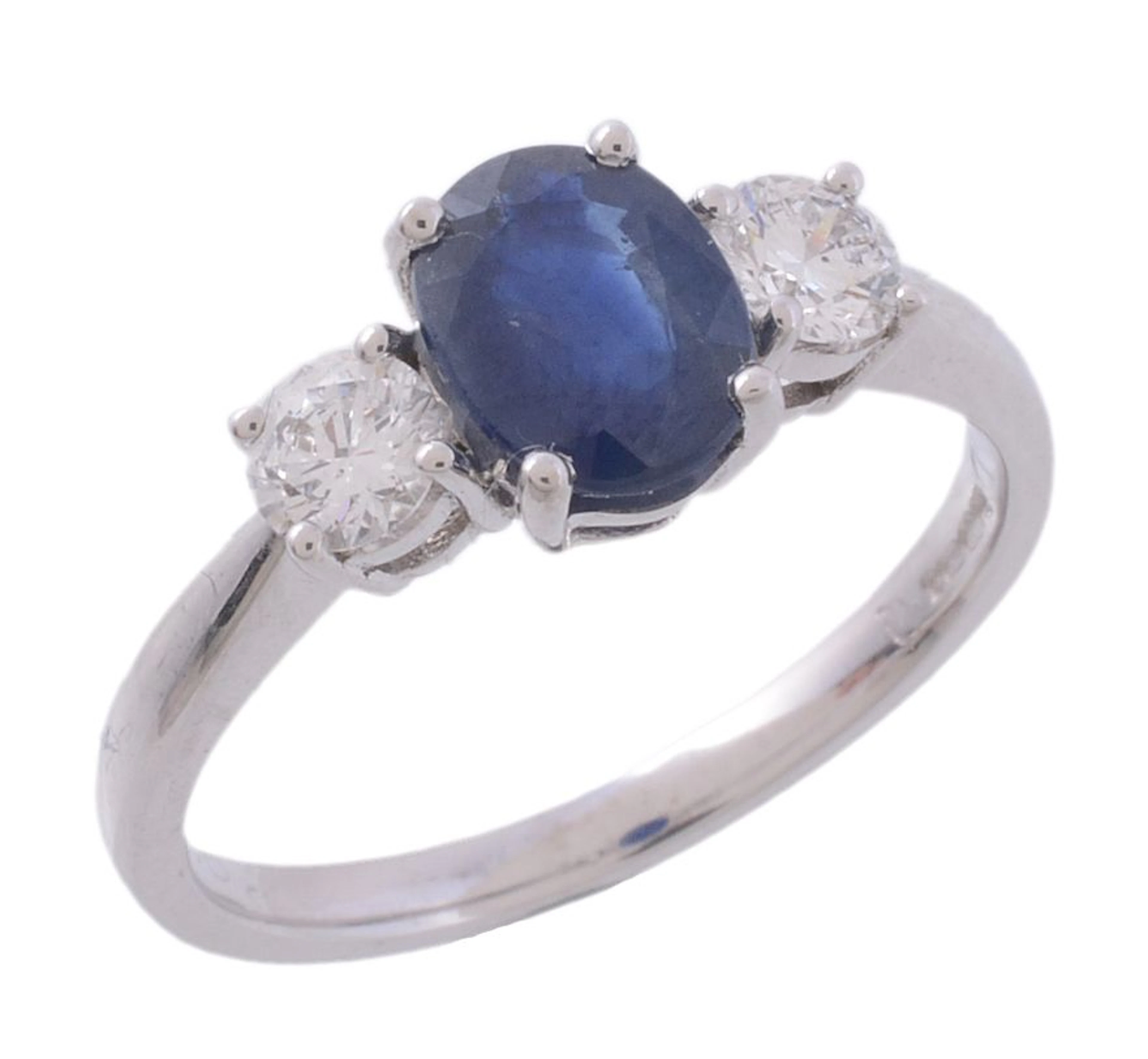 A sapphire and diamond ring, the central oval shaped sapphire in a claw setting