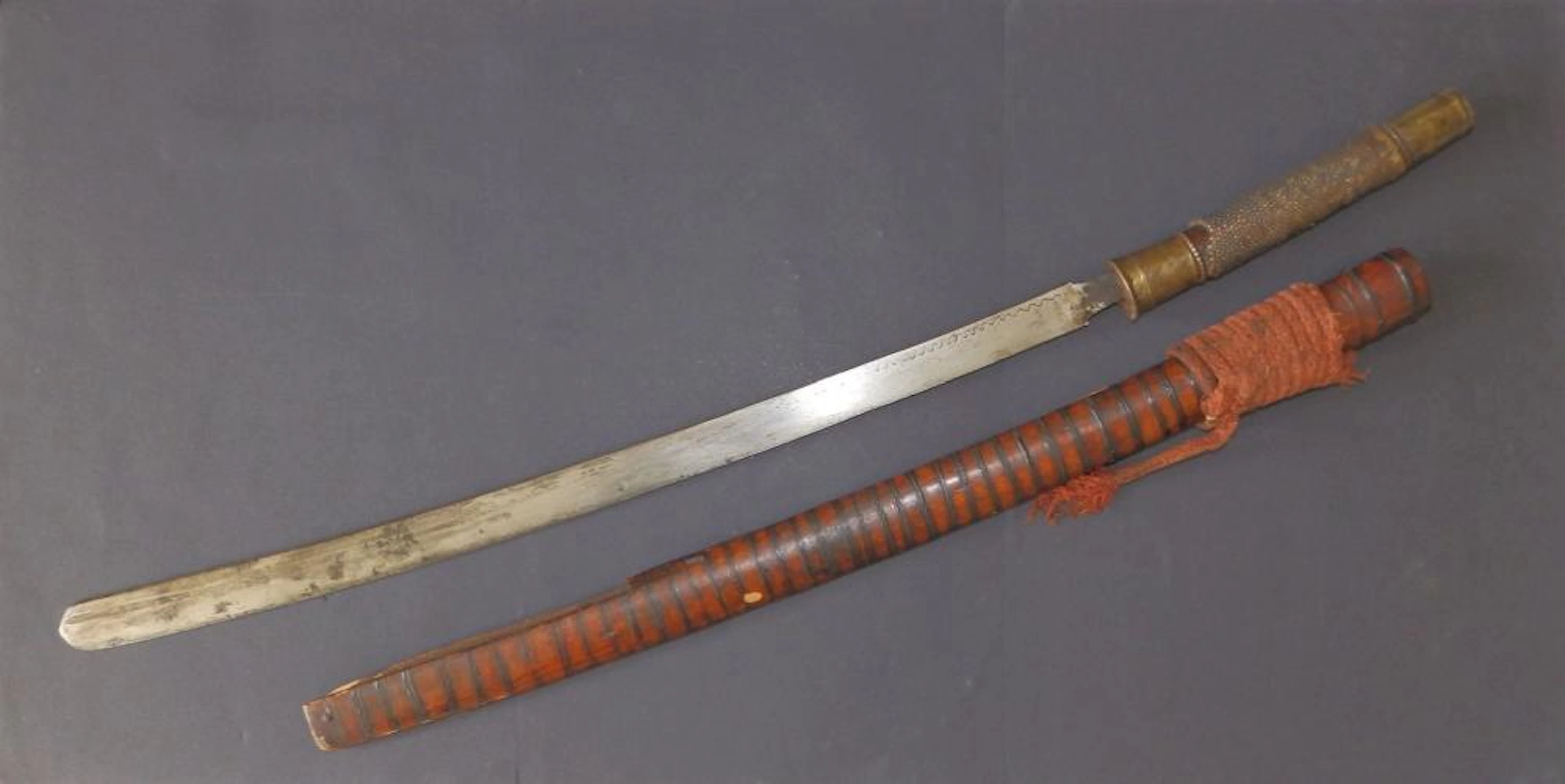 A 19thC Indonesian sword in wooden scabbard, havin?