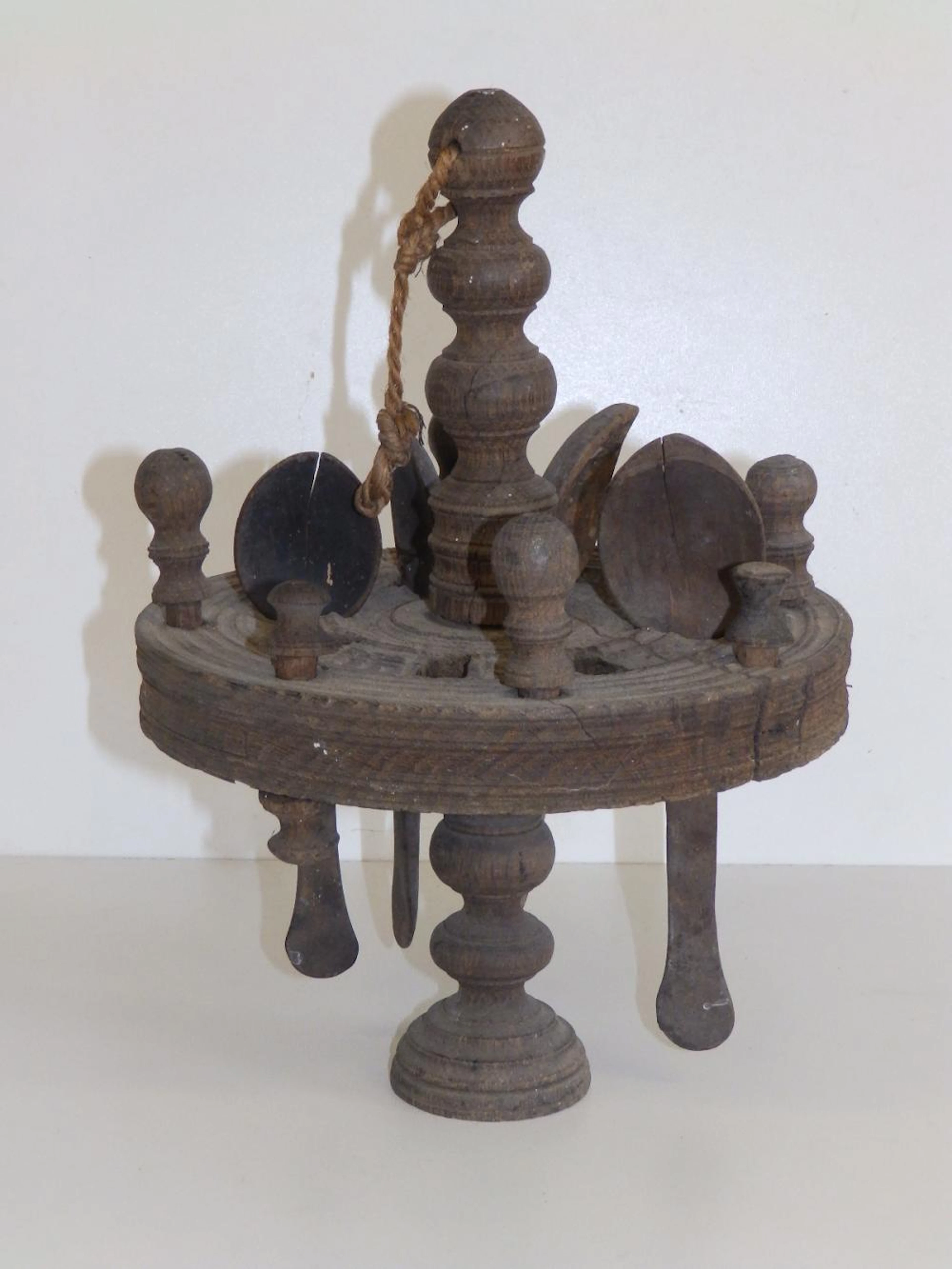 An antique revolving circular wooden spoon rack wi?
