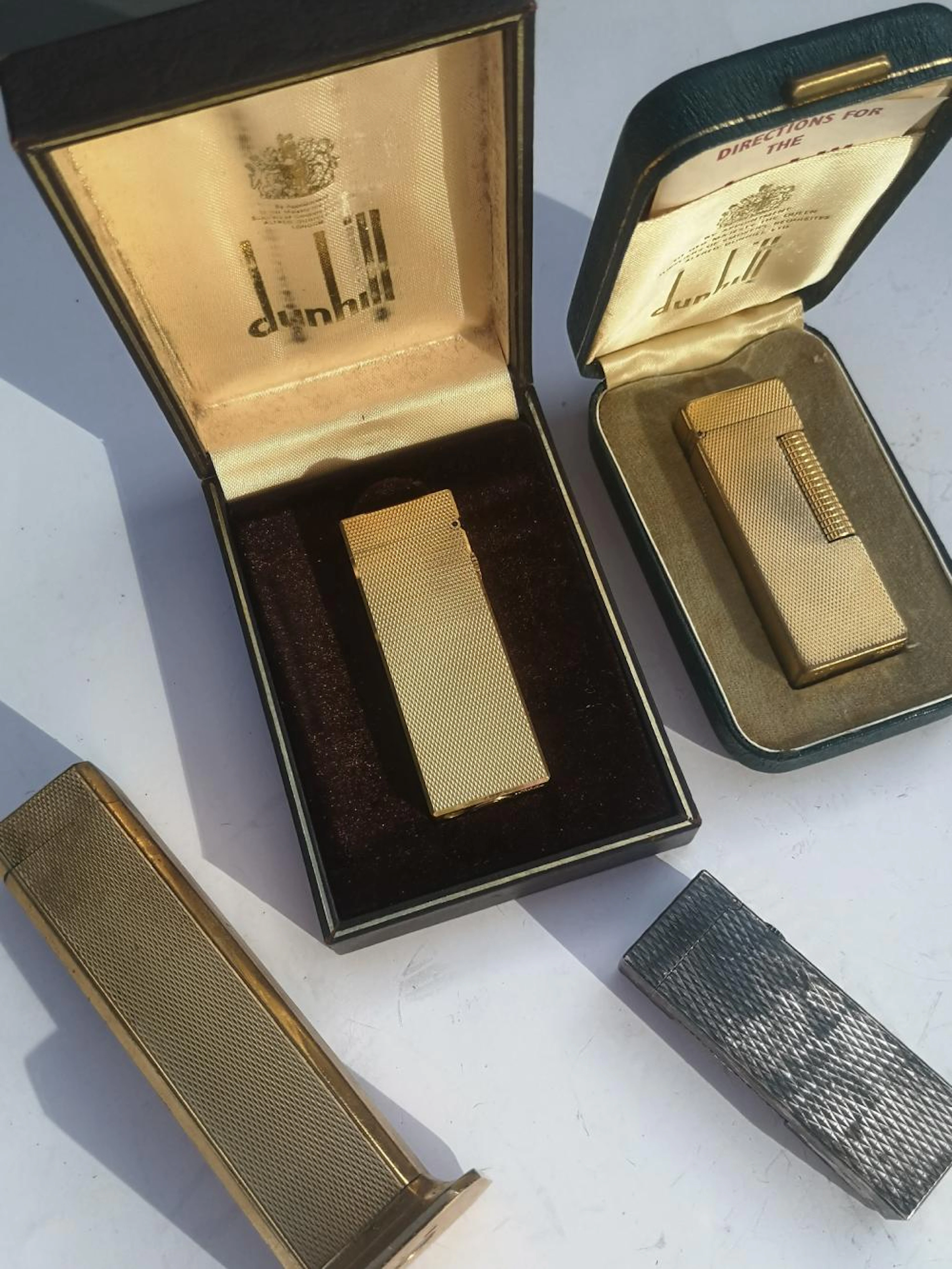 A Dunhill Tallboy lighter and three other Dunhill lighters. (4)