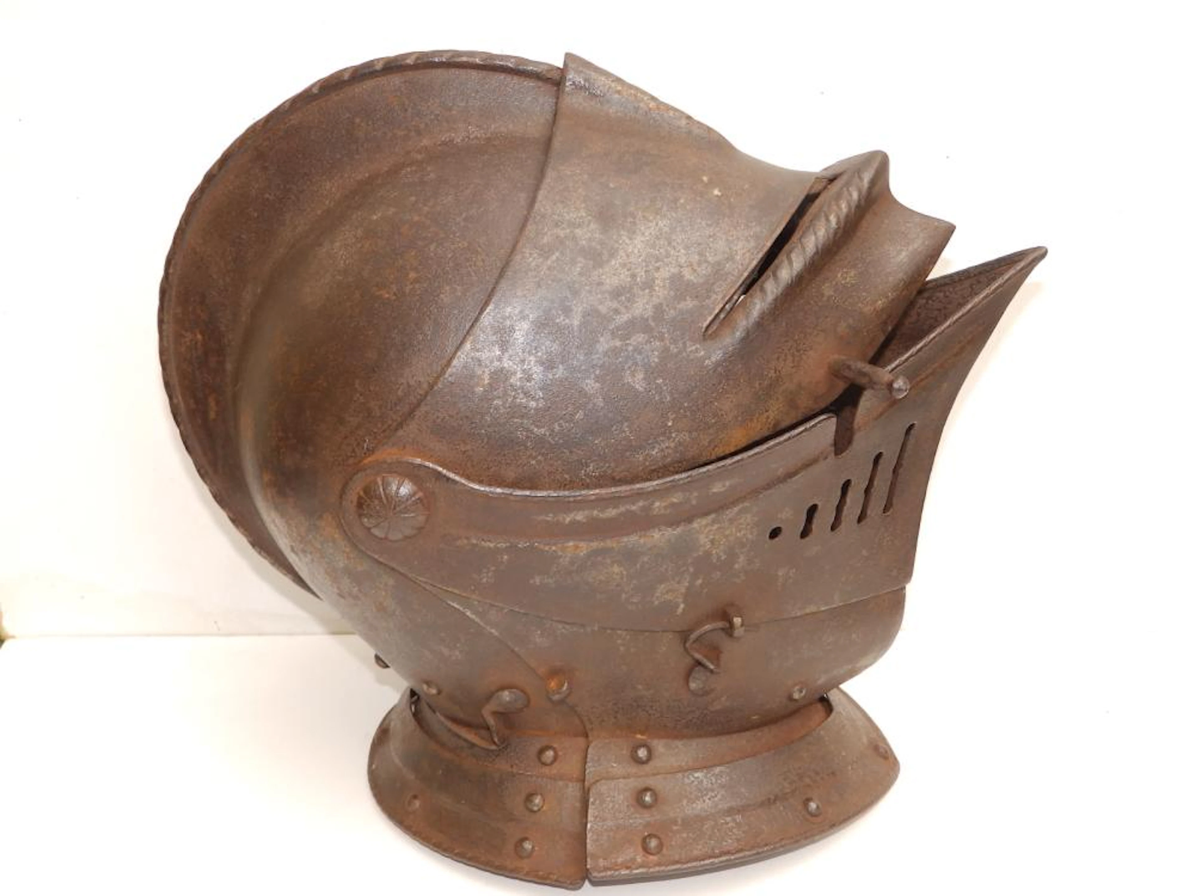 An antique close helm with roped comb, 13.5" across.