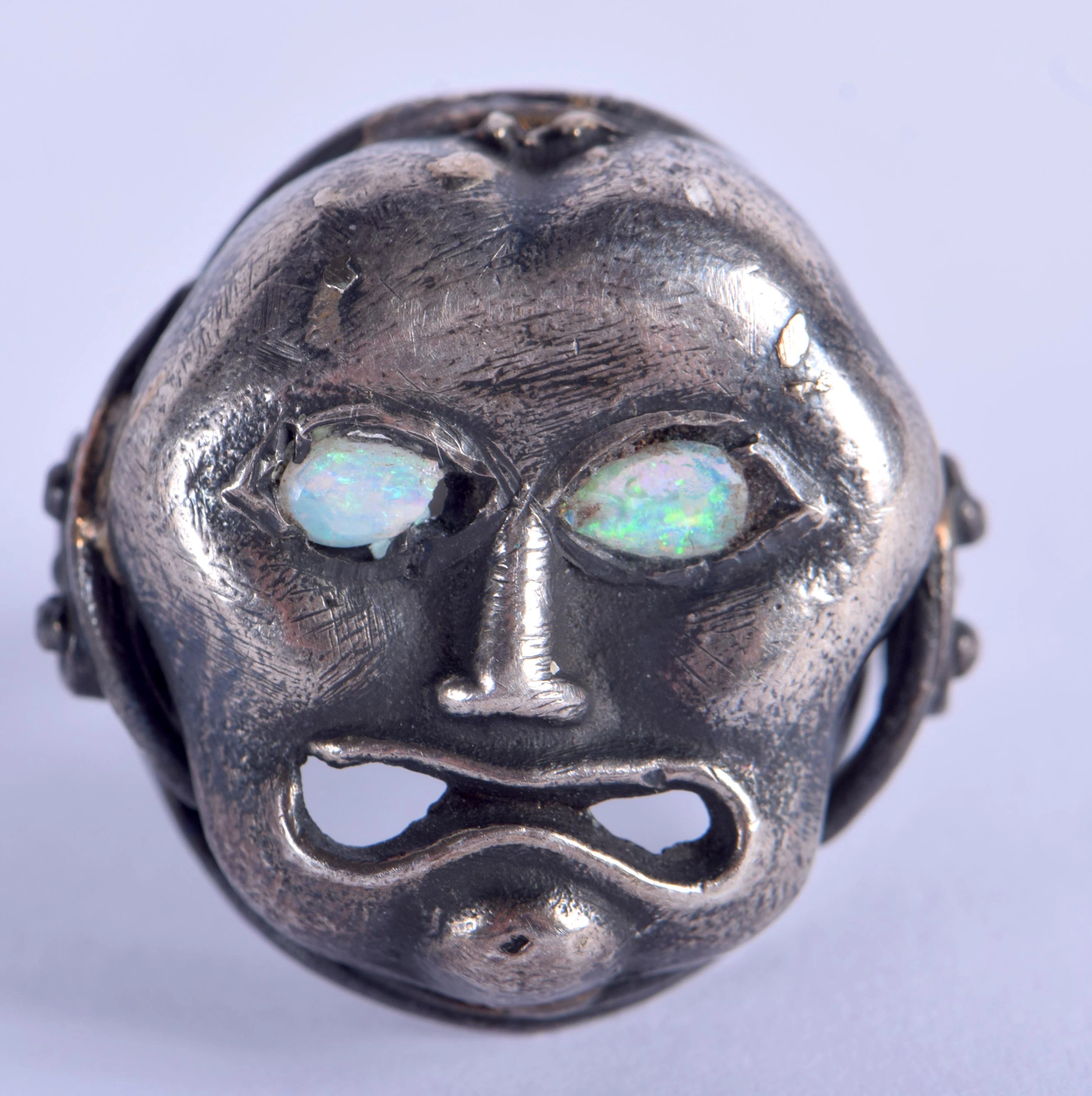 A silver and opal mask ring. n.