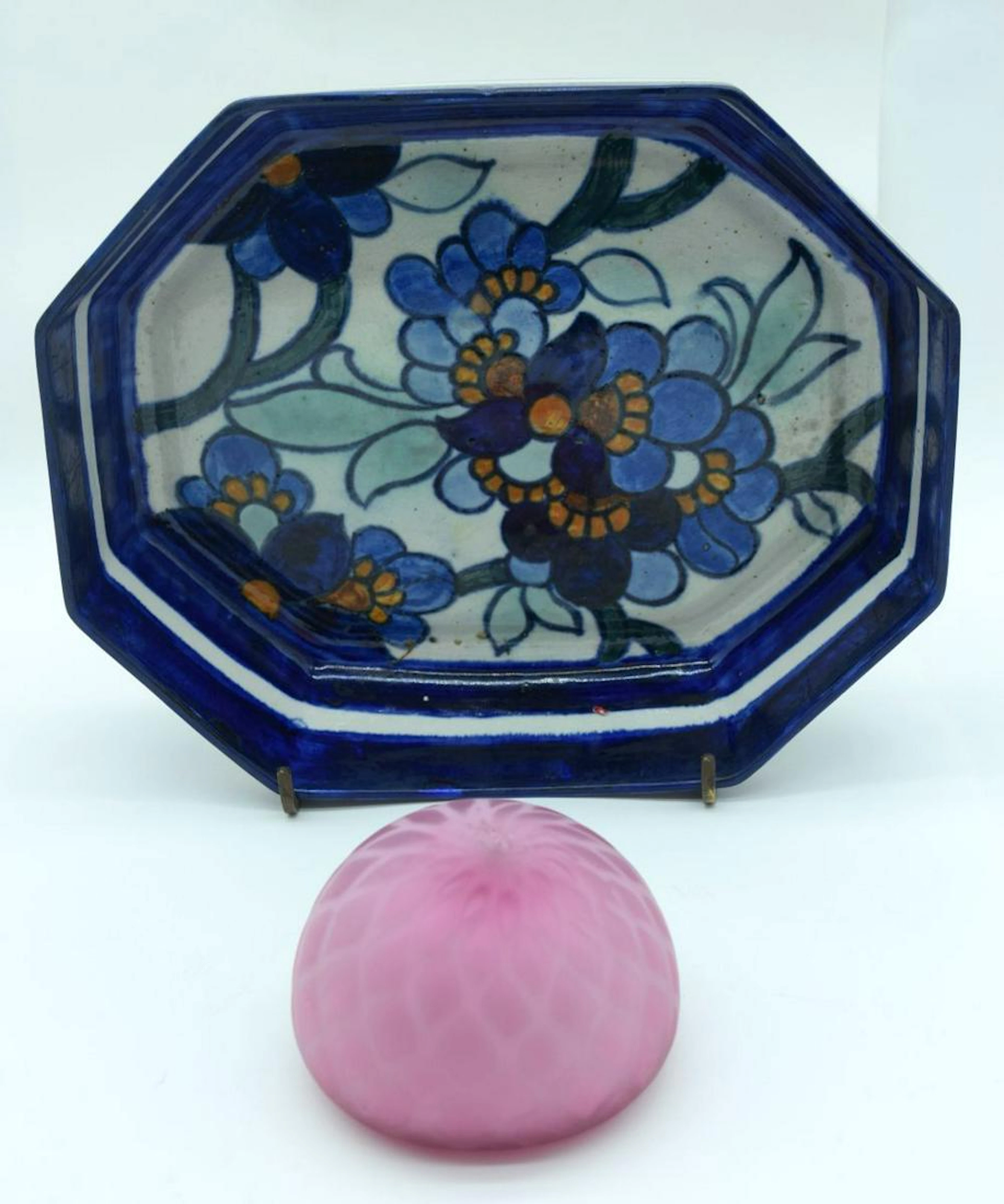 A glazed pottery dish decorated with flowers together