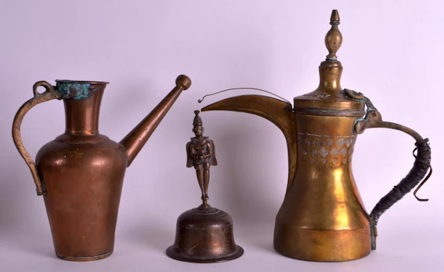 A 19TH CENTURY TIBETAN PATINATED BRASS BELL depicting