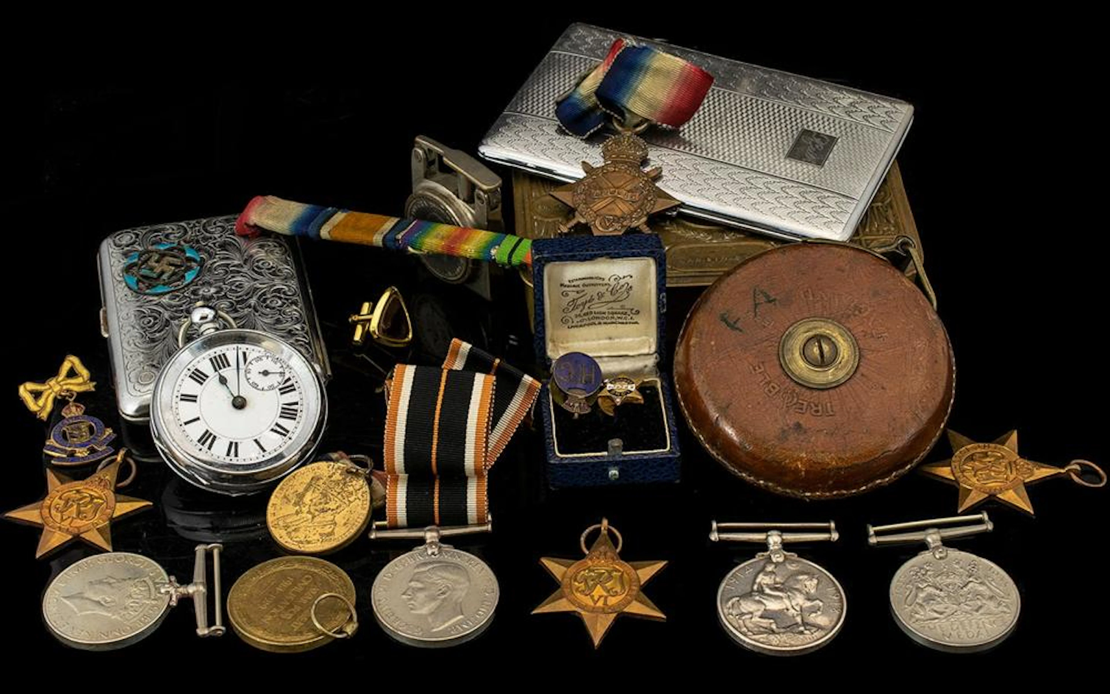Military Interest. A Tin containing a quantity to include three WW1 medals