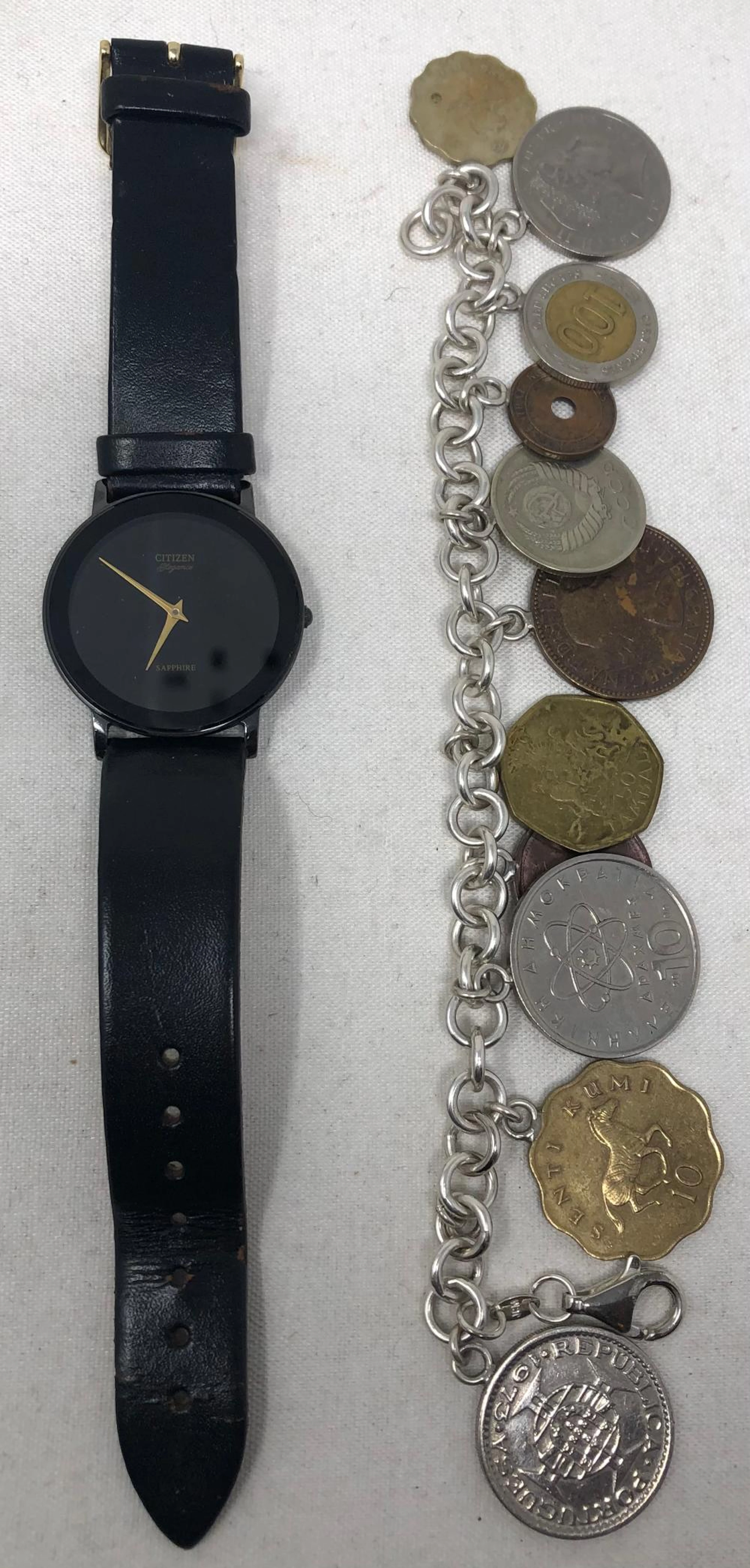Foreign Coin Charm Bracelet and Citizen Wristwatch; eleven coins include Republica Portugal 1975, Senti Kuma 10 Tanzania Rais wa Kawanze 1984, 10 Hmokpati, Canada One Cent, Malawi 50 Tambal 1996, Eliz