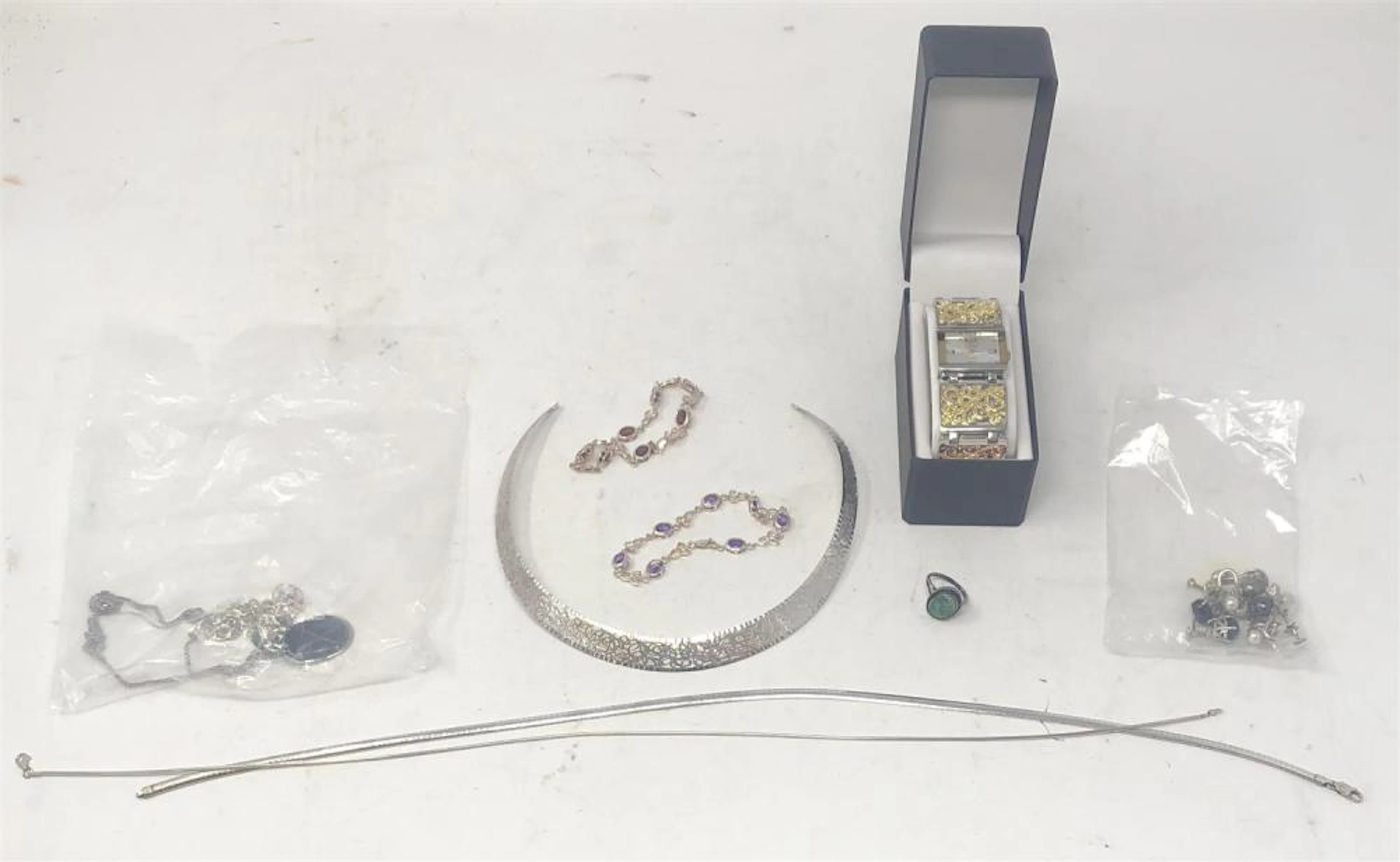 Collection of sterllng and other jewelry comprising: one new lady's reticulated quartz watch by Vivani, three sterling silver choker..