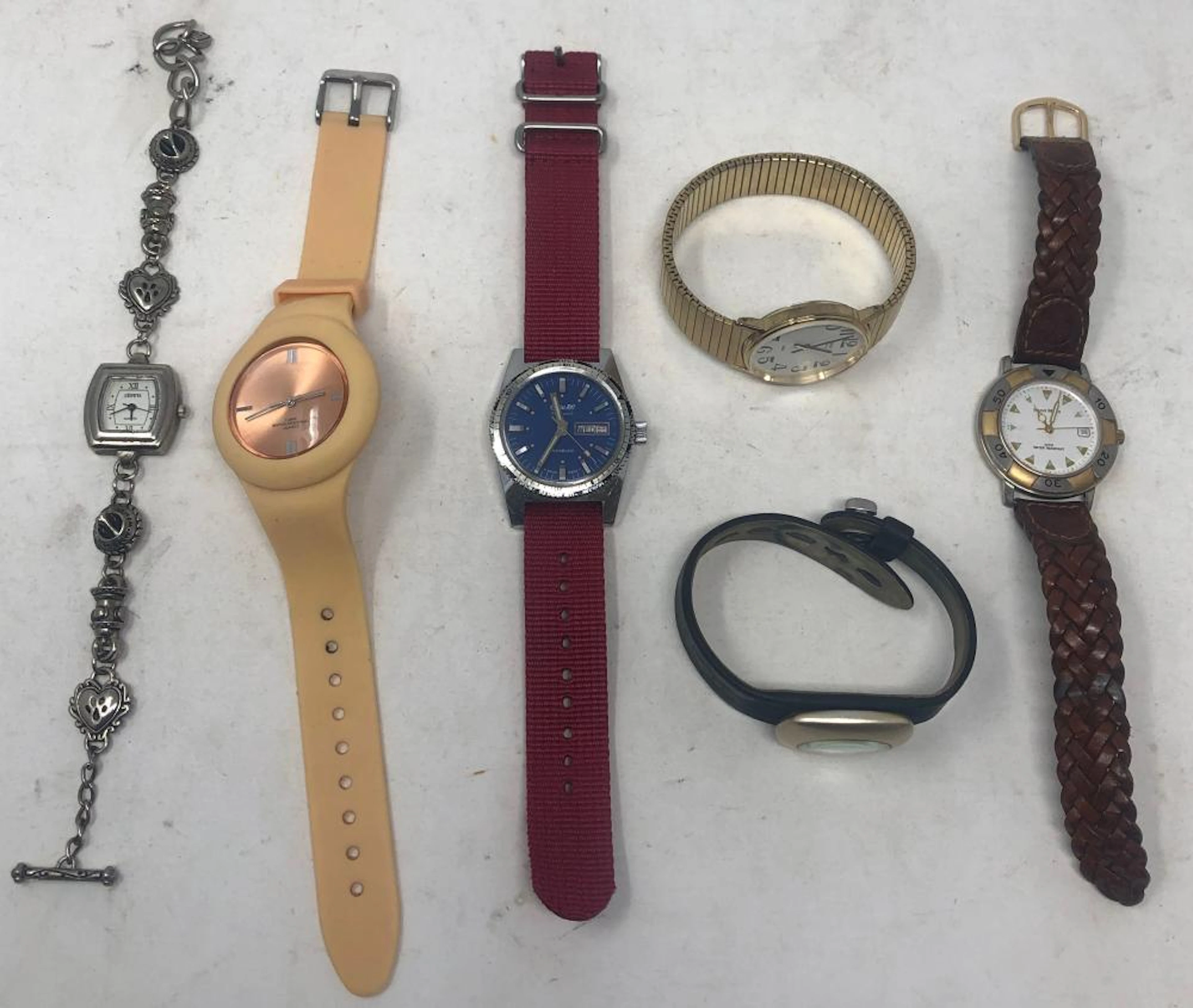 Six watches include: Alessi Designer with black felt strap; Incabloc Swiss 100 25 jewel on red cloth band; Hugo Maxx with Irish Ravodo leather band; Geneva quartz on silver tone bracelet band; Mans Ti