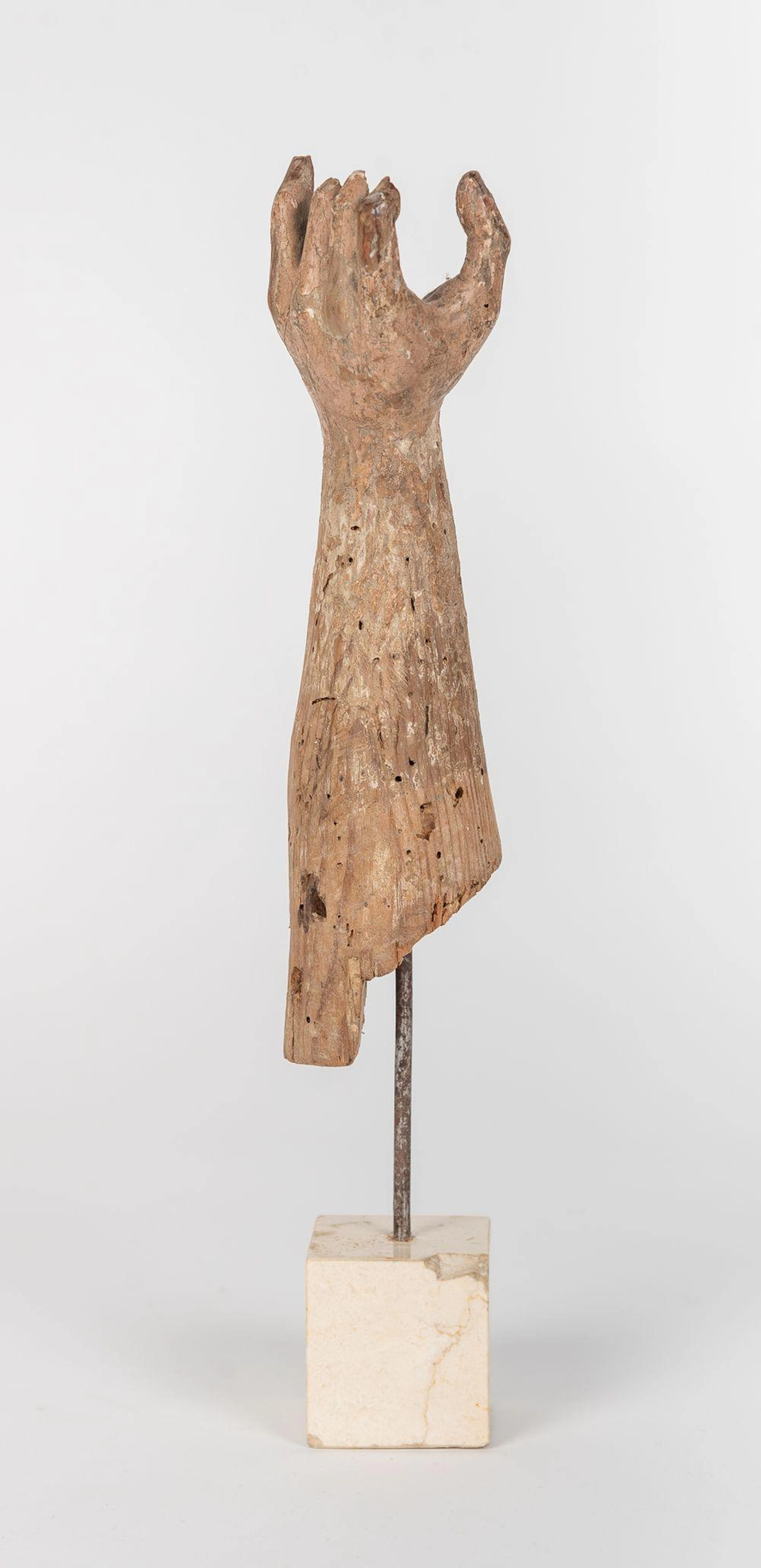 Antebrazo realizado en madera tallada y policromada sobre peana de mármol