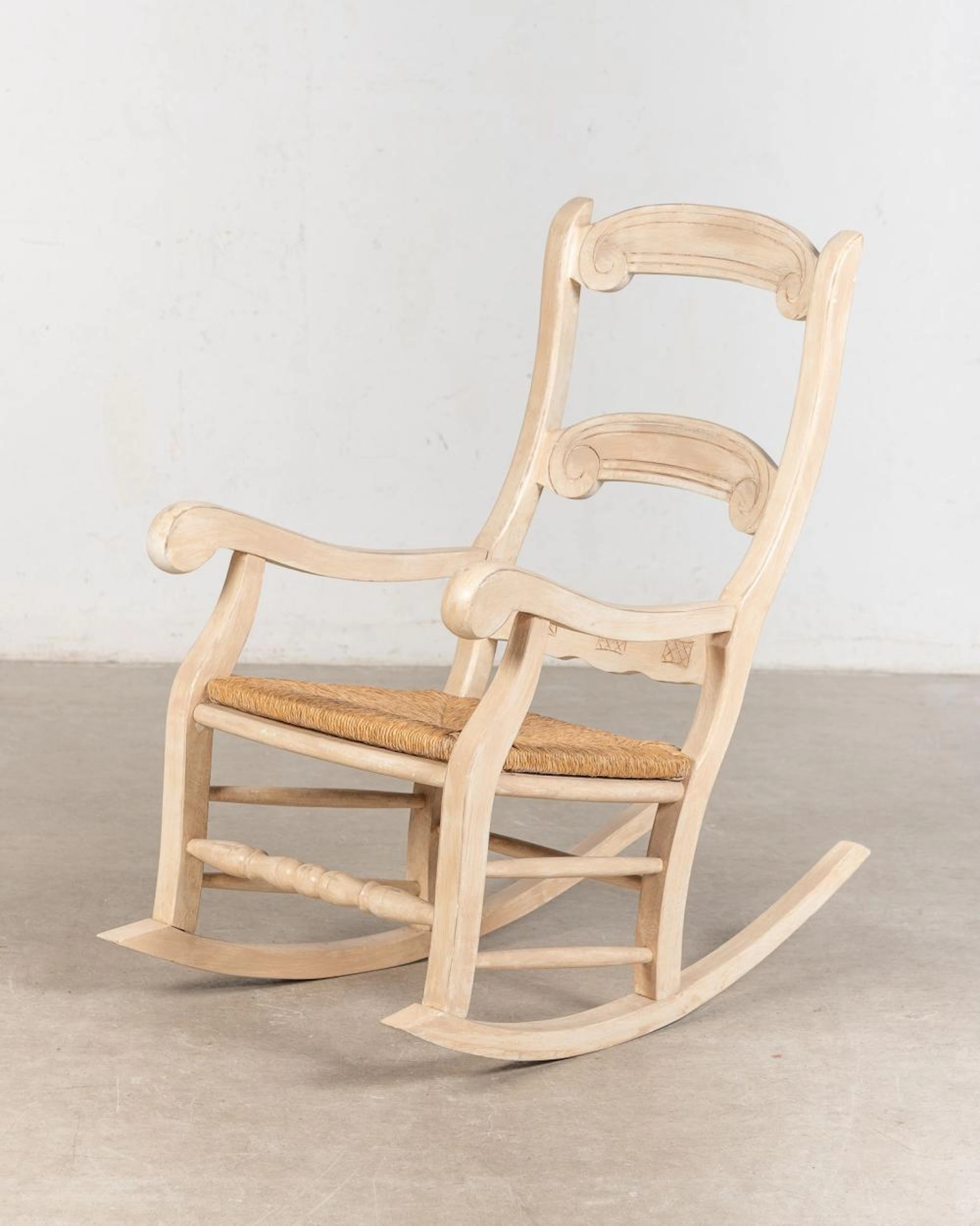 Mecedora realizada en madera lacada en blanco.