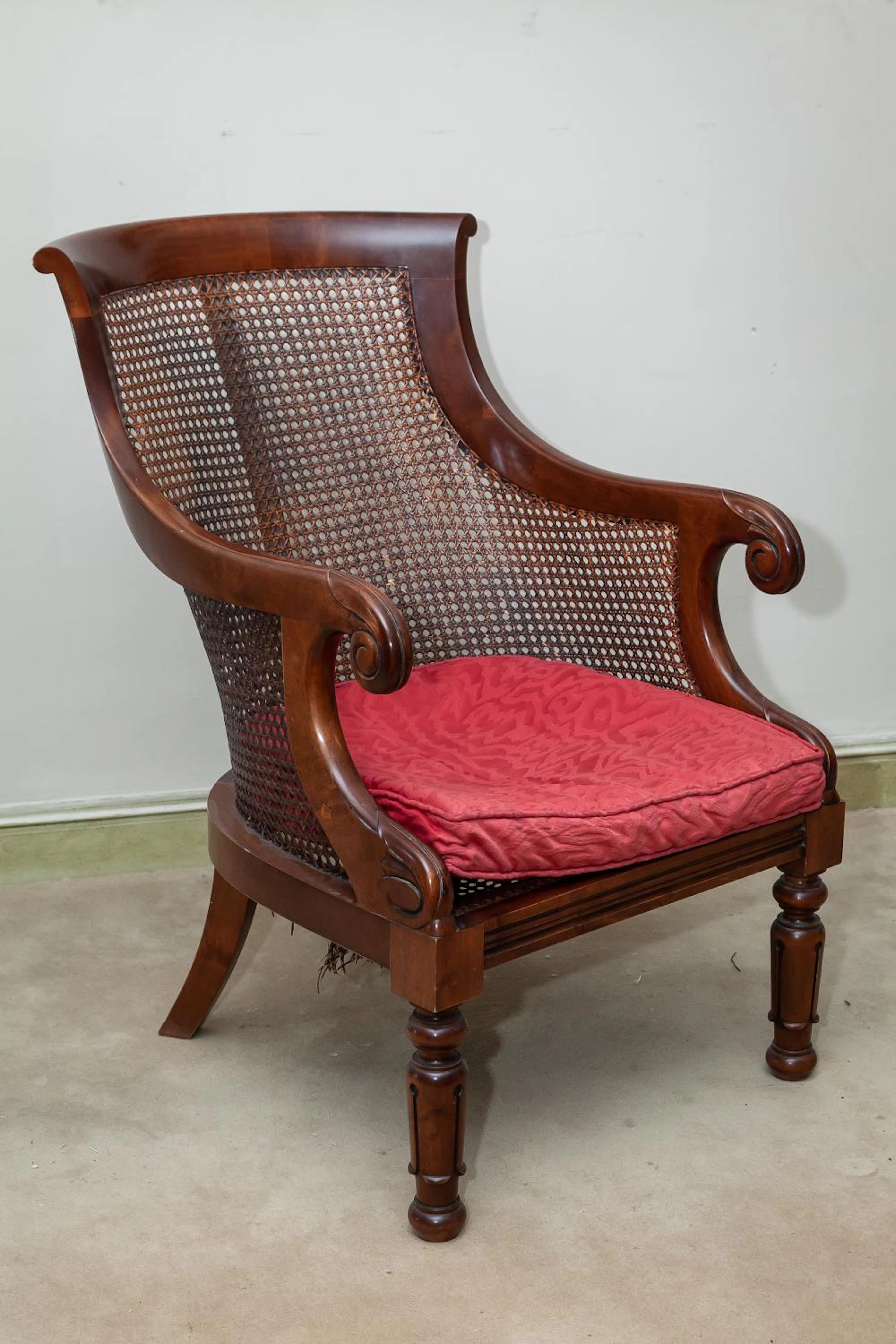 A George IV style mahogany caned slipper chair