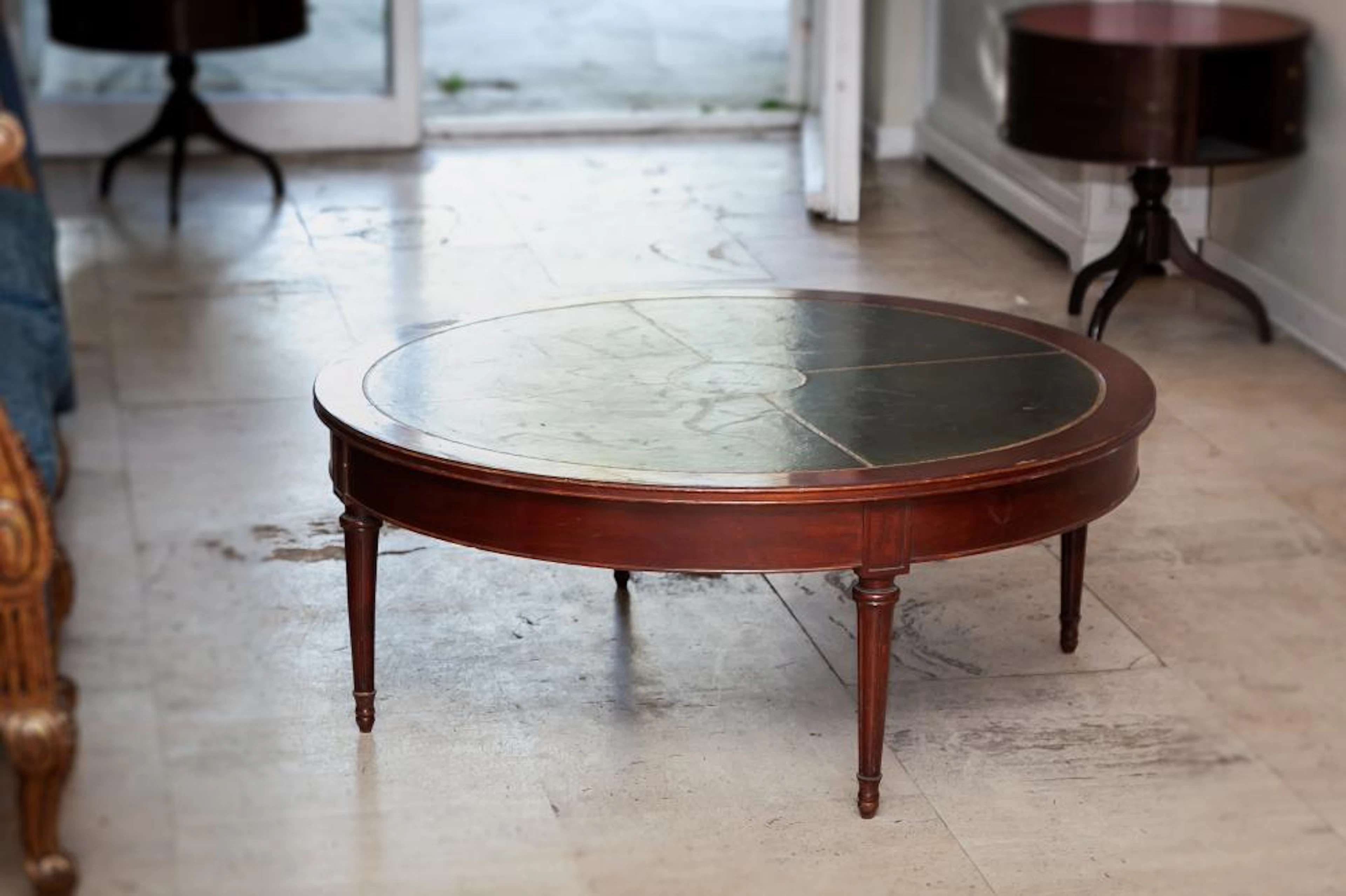 A leather topped mahogany low table