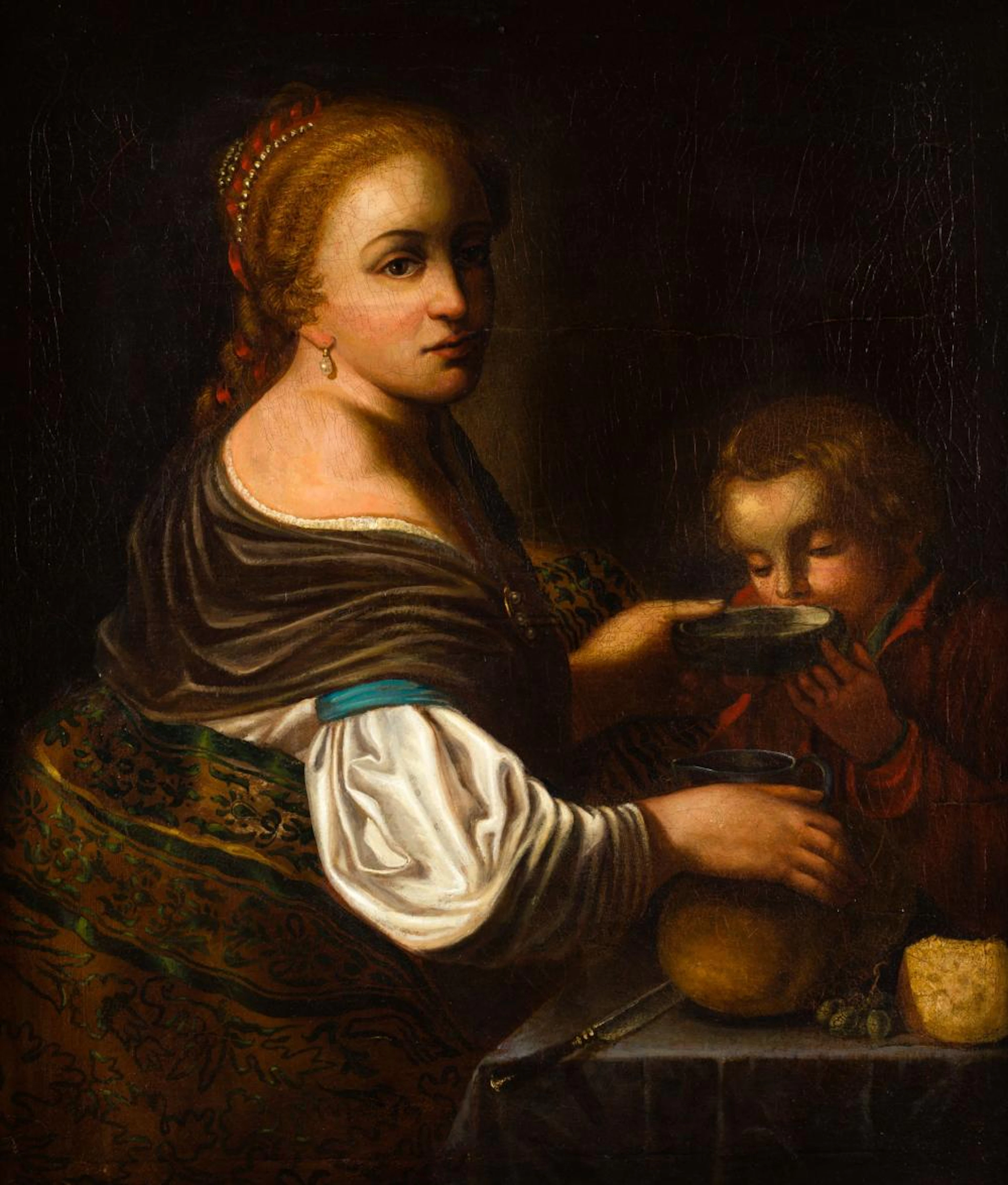 FOLLOWER OF NICOLAES MAES (18th century/19th century) "Woman feeding a child"