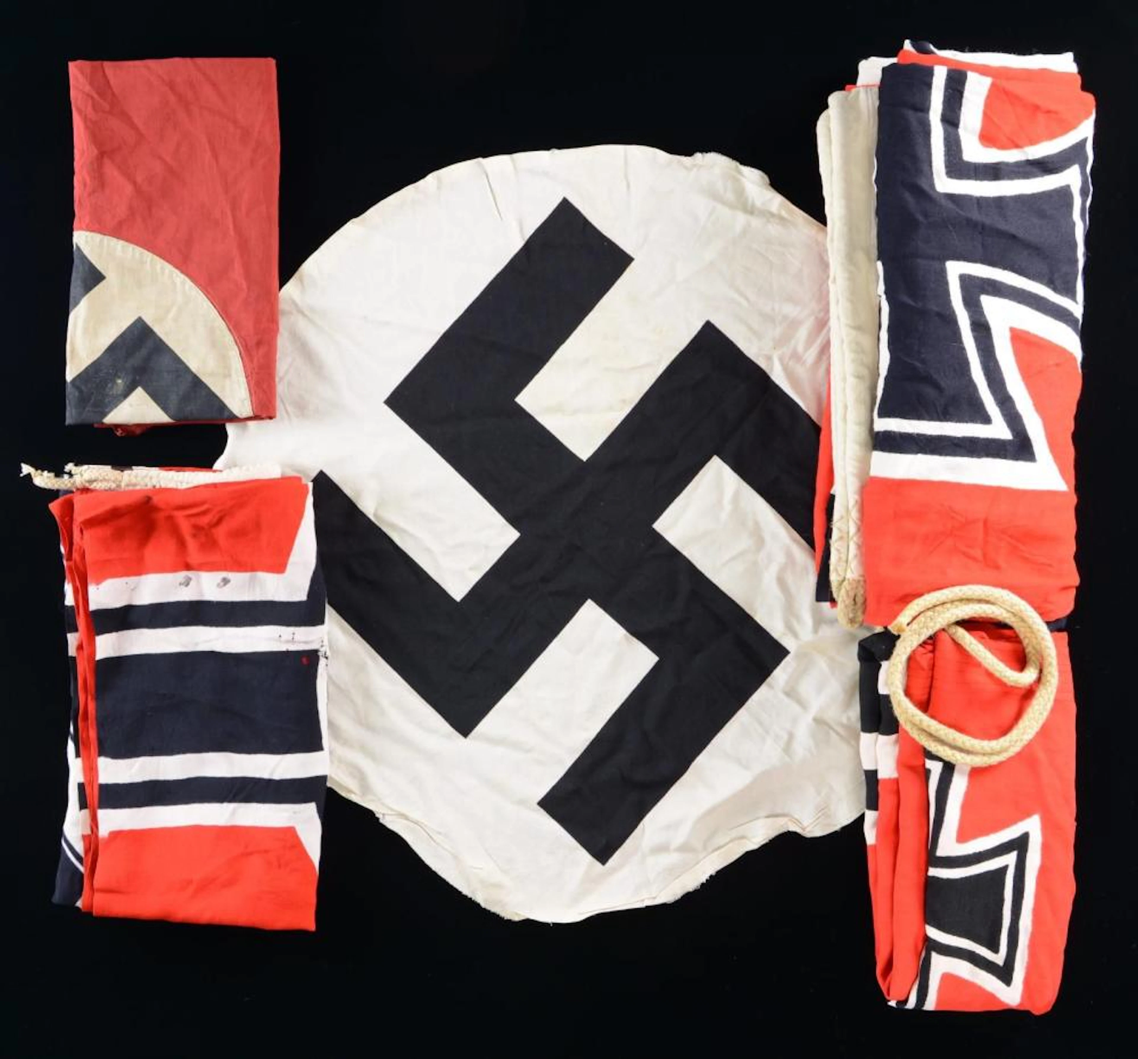 4 WWII GERMAN FLAGS & A CENTER DEVICE.