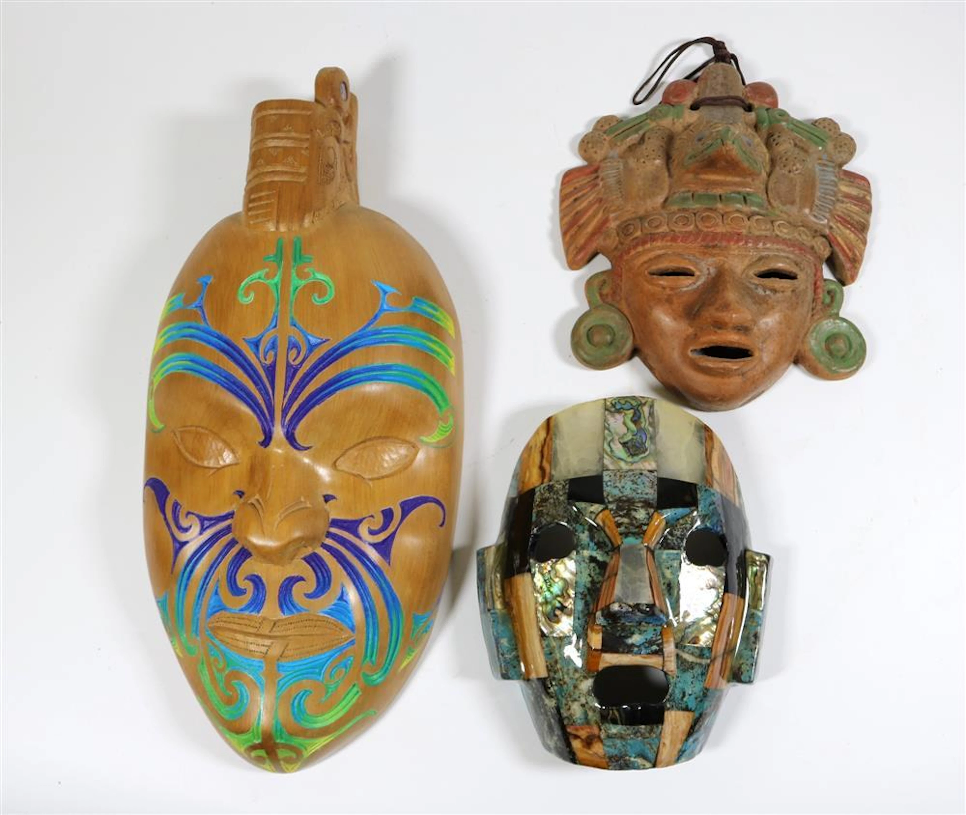THREE DECORATIVE FACE MASKS; ONE FROM NEW ZEALAND AND TWO FROM LATIN AMERICA,