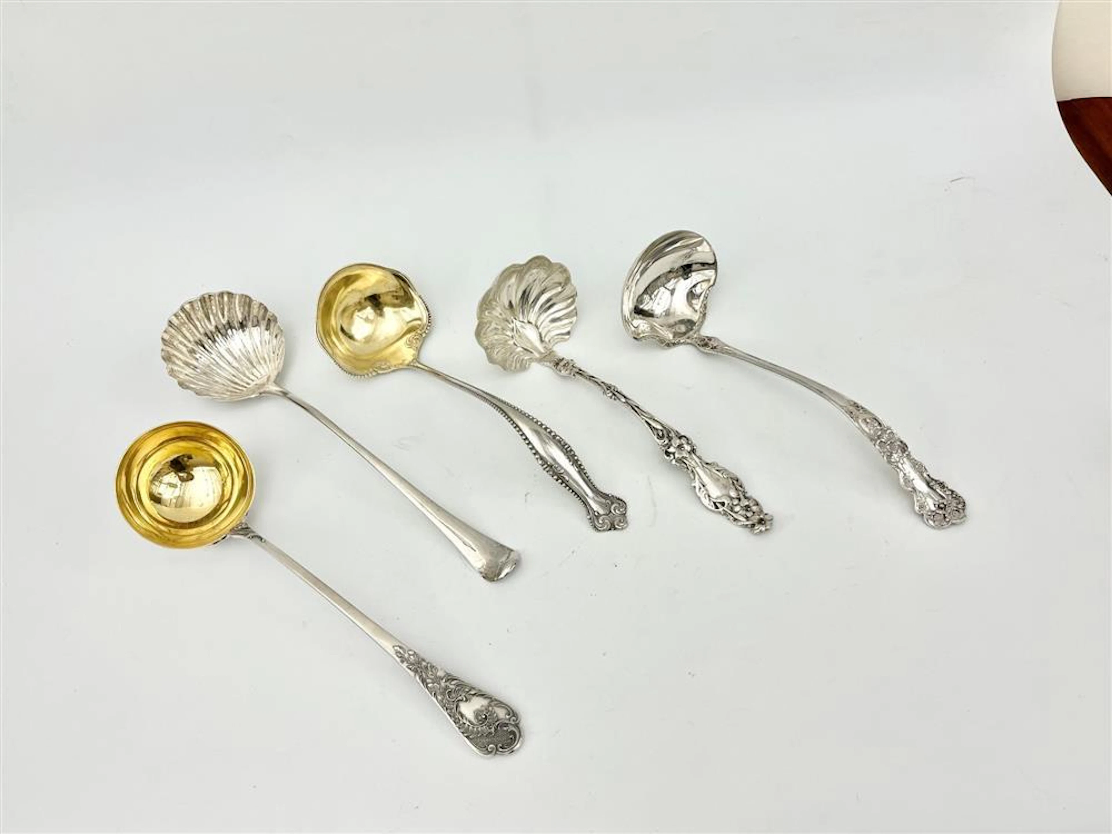 FIVE ASSORTED SILVER SOUP LADLES. 18th-19th century. - Wt: 35.8 troy oz.
