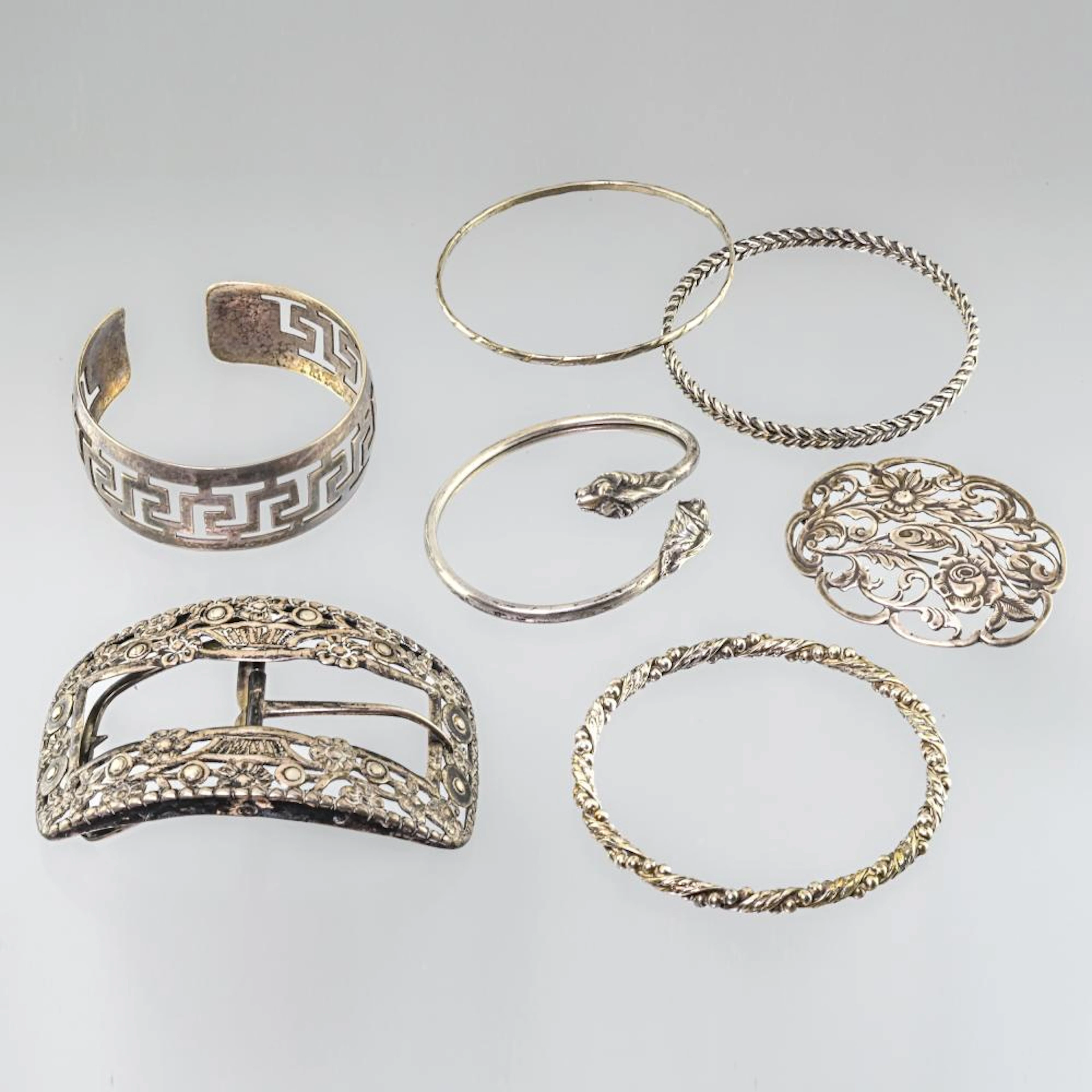 Lot of five bracelets, a brooch and a belt buckle