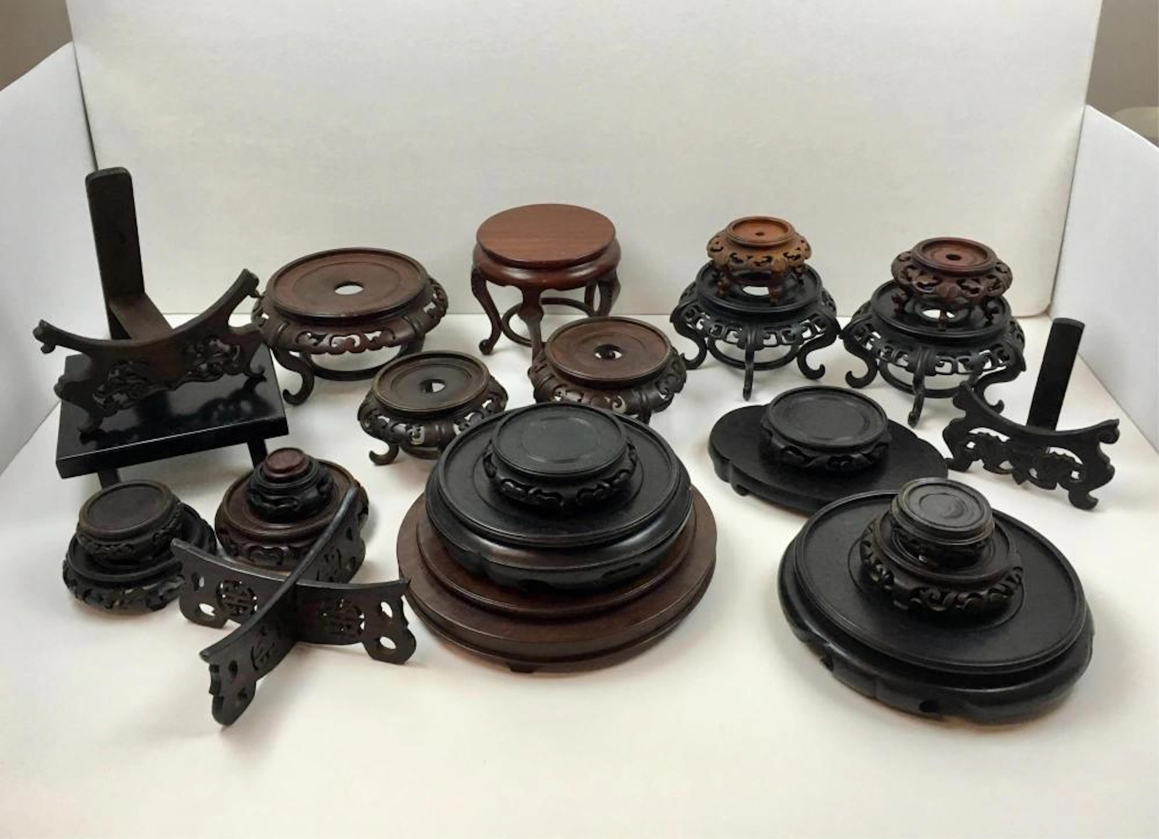 TWENTY FIVE CARVED CHINESE WOODEN STANDS